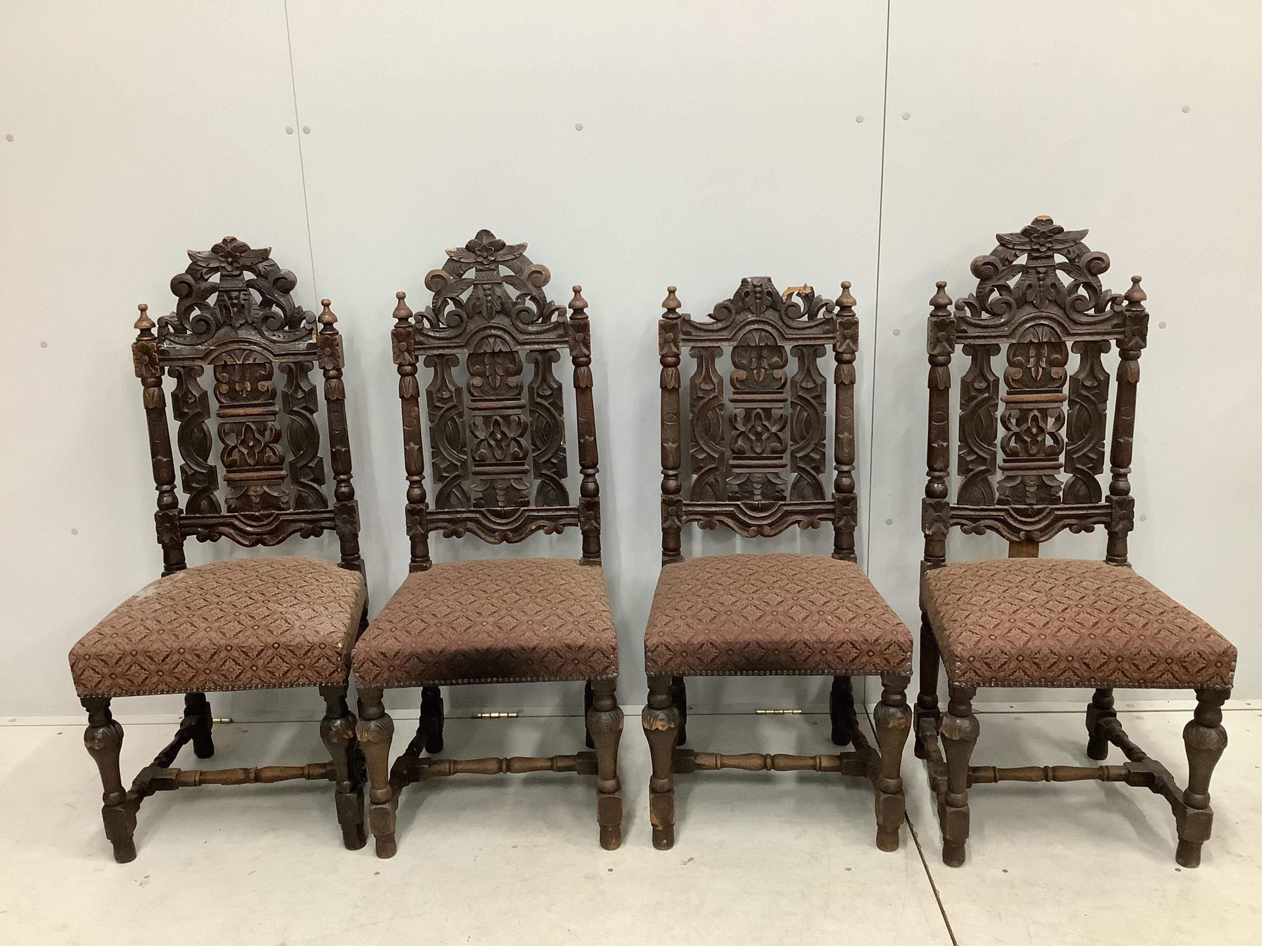 A set of thirteen carved Victorian oak dining chairs, one with arms. Condition - poor to fair